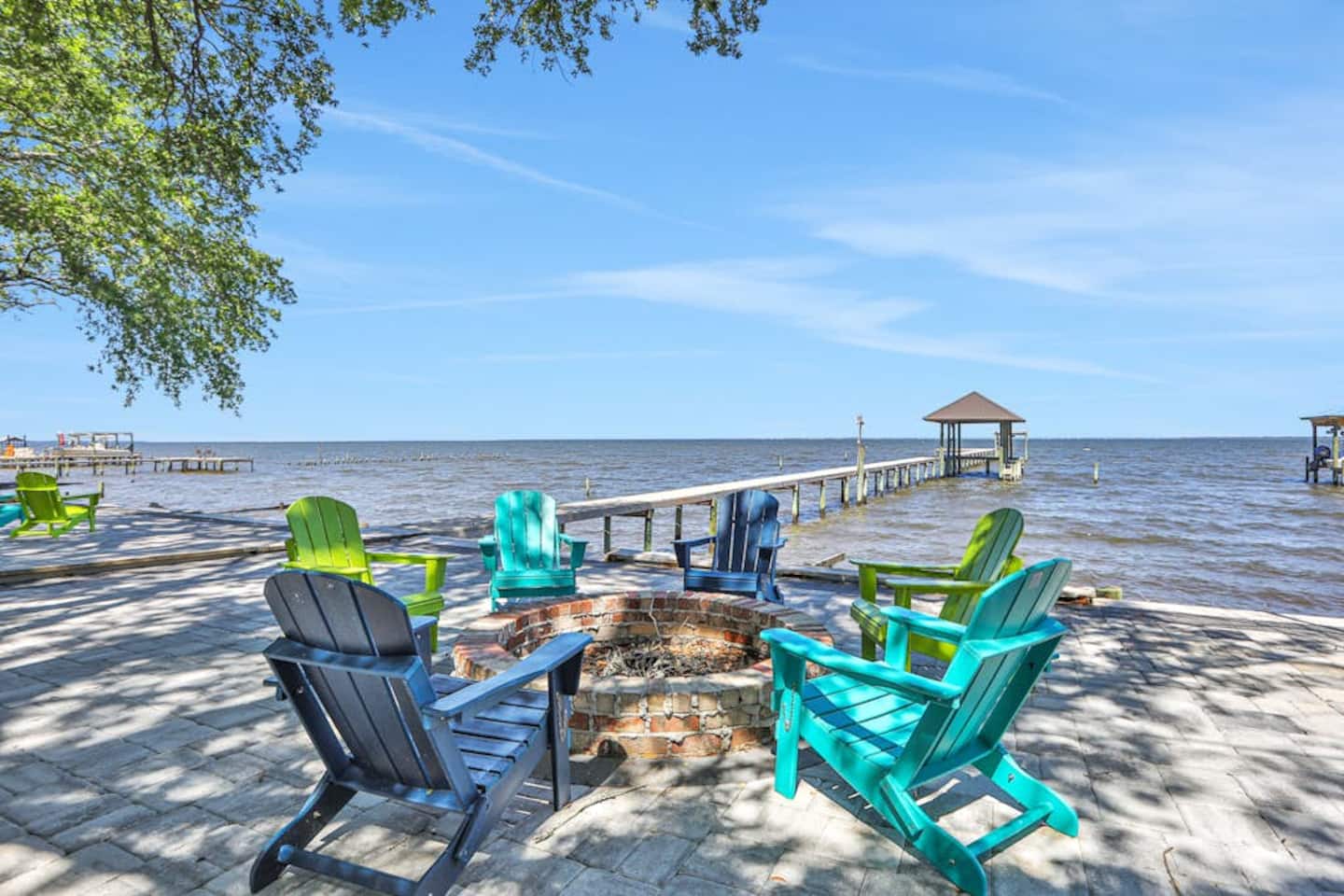 Waterfront fire pit and private dock at Bayfront Bliss in Gulf Breeze, Florida
